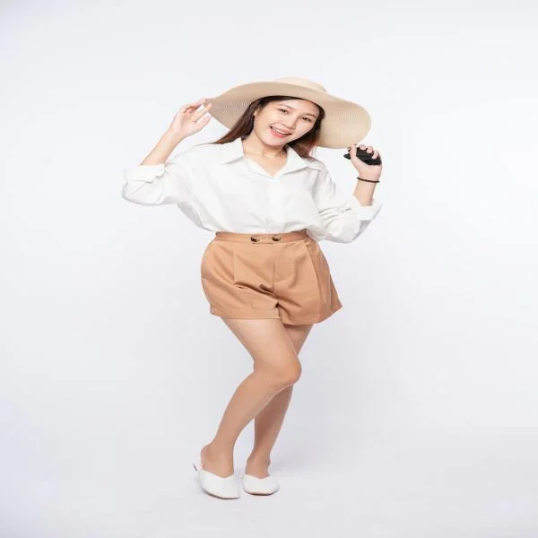 young-woman-wearing-white-shirt-shorts-wearing-hat-handle-hat-1
